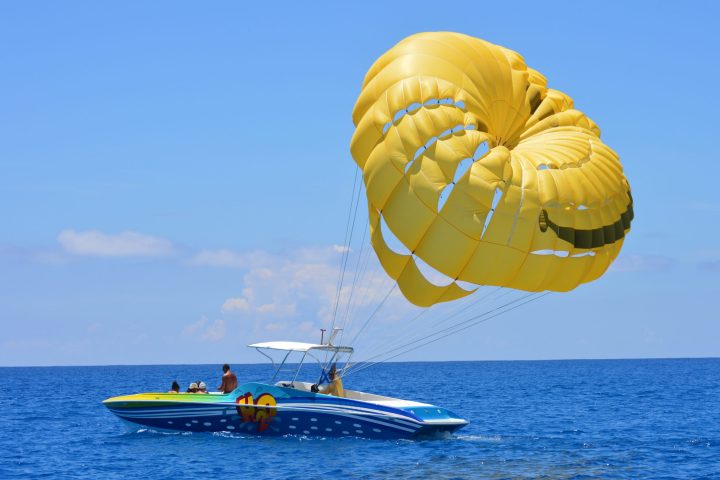 a blue and white boat floating on a body of water